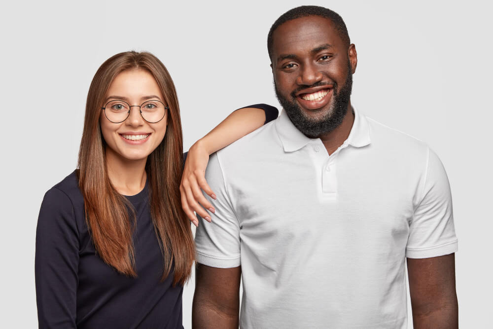 Race Awareness Training Advanced Black male and white woman smiling next to each other
